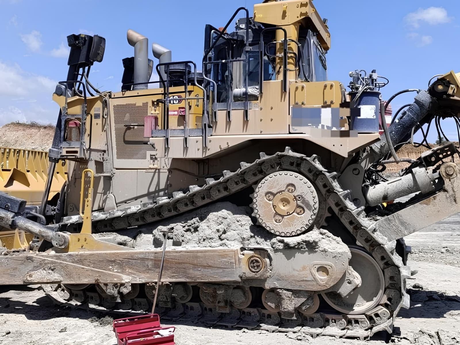 Heavy crawler bulldozer undercarriage on active mining site
